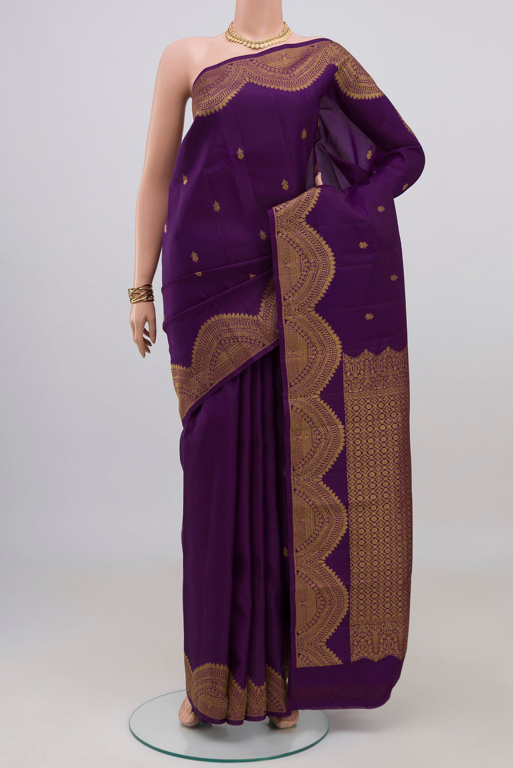 Violet Kanchipuram Silk Saree with Zari Butta on the body and Fancy Border.  displayed on a mannequin