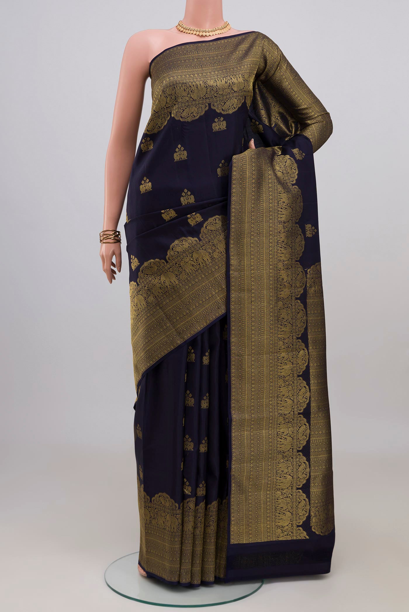 Navy Blue Kanchipuram Silk Saree with Zari Butta on the body and Fancy Border.  displayed on a mannequin