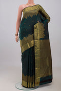 Bottle Green Kanchipuram Silk Saree with Zari Butta on the body and Zari Border.  displayed on a mannequin
