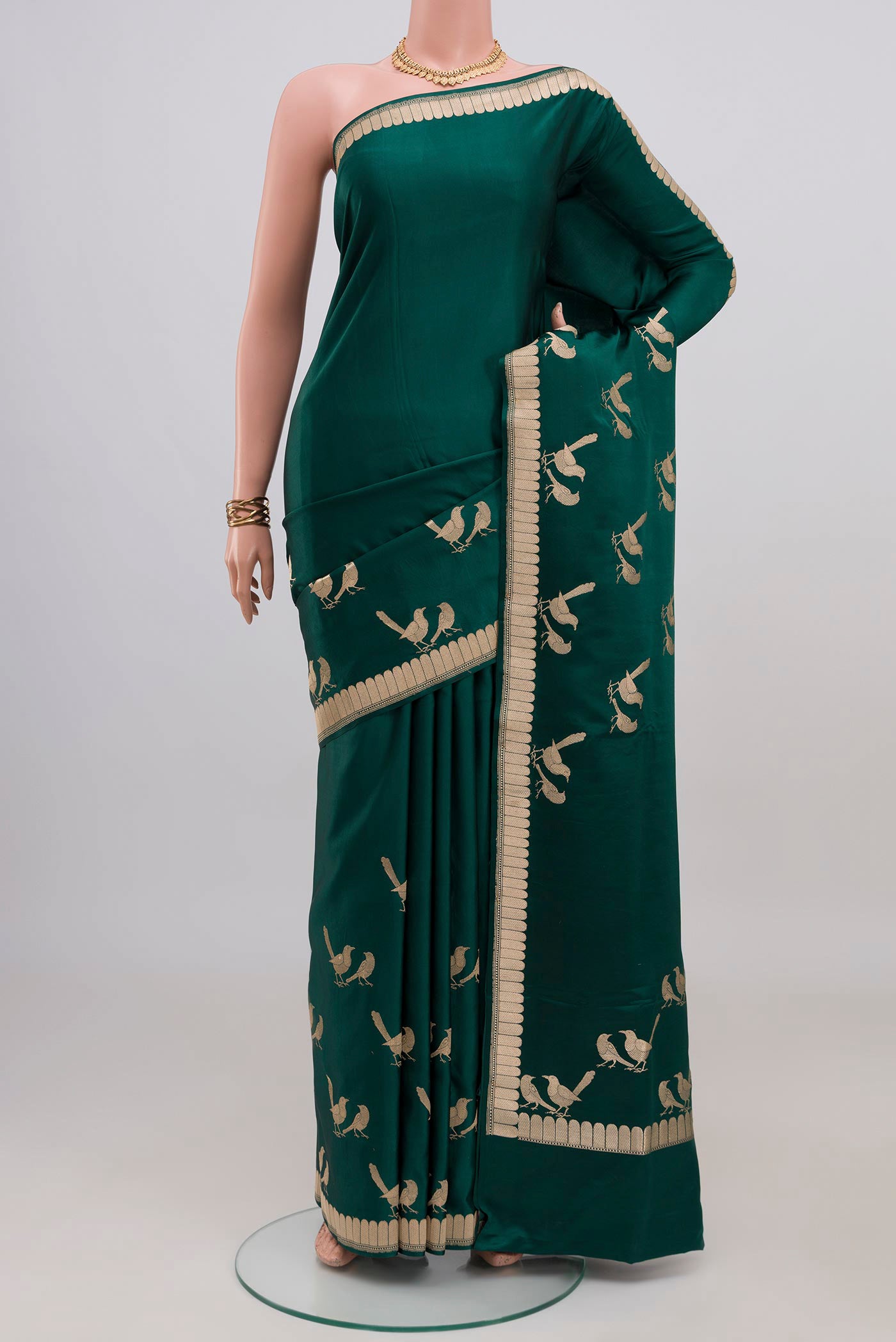 Bottle Green Banarasi Silk Saree with Plain Body and Fancy Border.  displayed on a mannequin