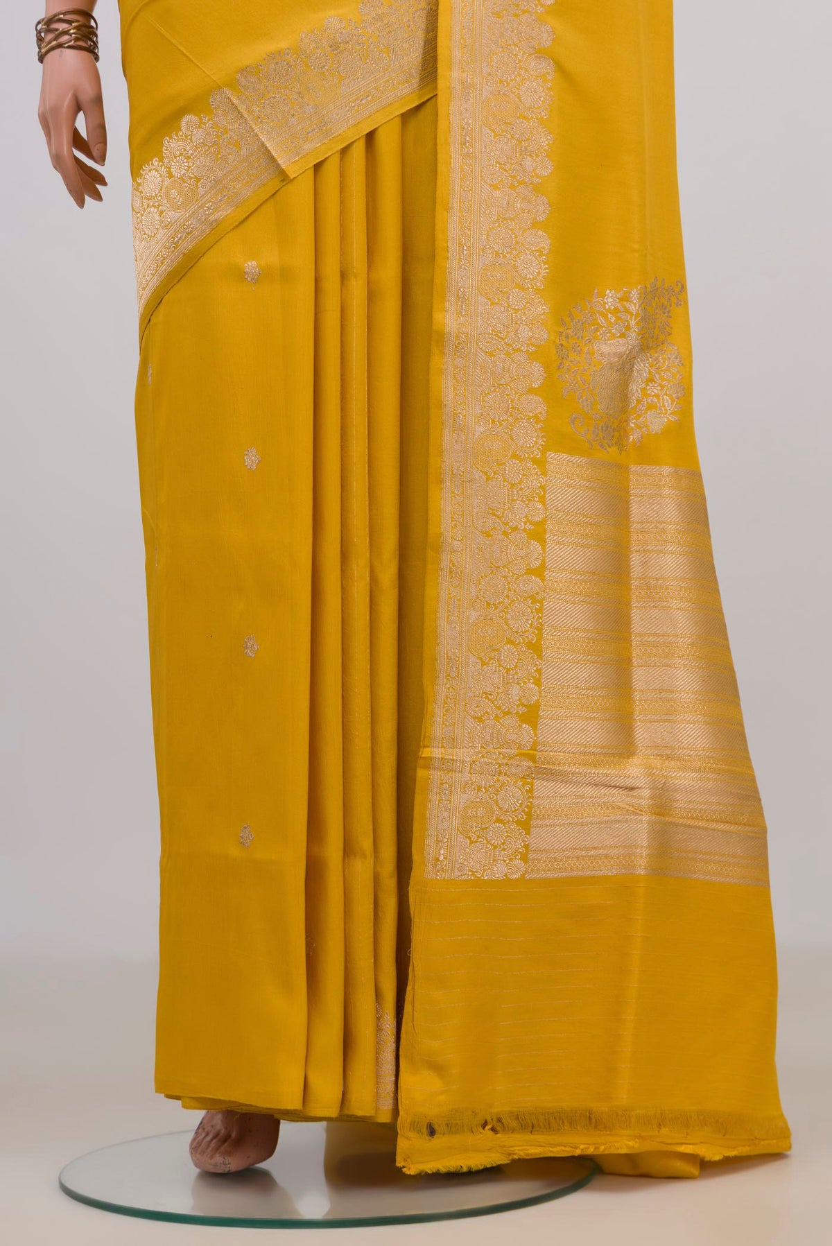 Pleats and pallu of Pure Silk Yellow Banarasi Saree with Plain Body and Fancy Border. 