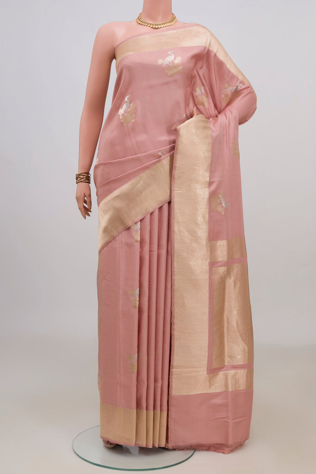 Pure Silk Peach Banarasi Saree with Zari Butta on the body and Fancy Border.  displayed on a mannequin
