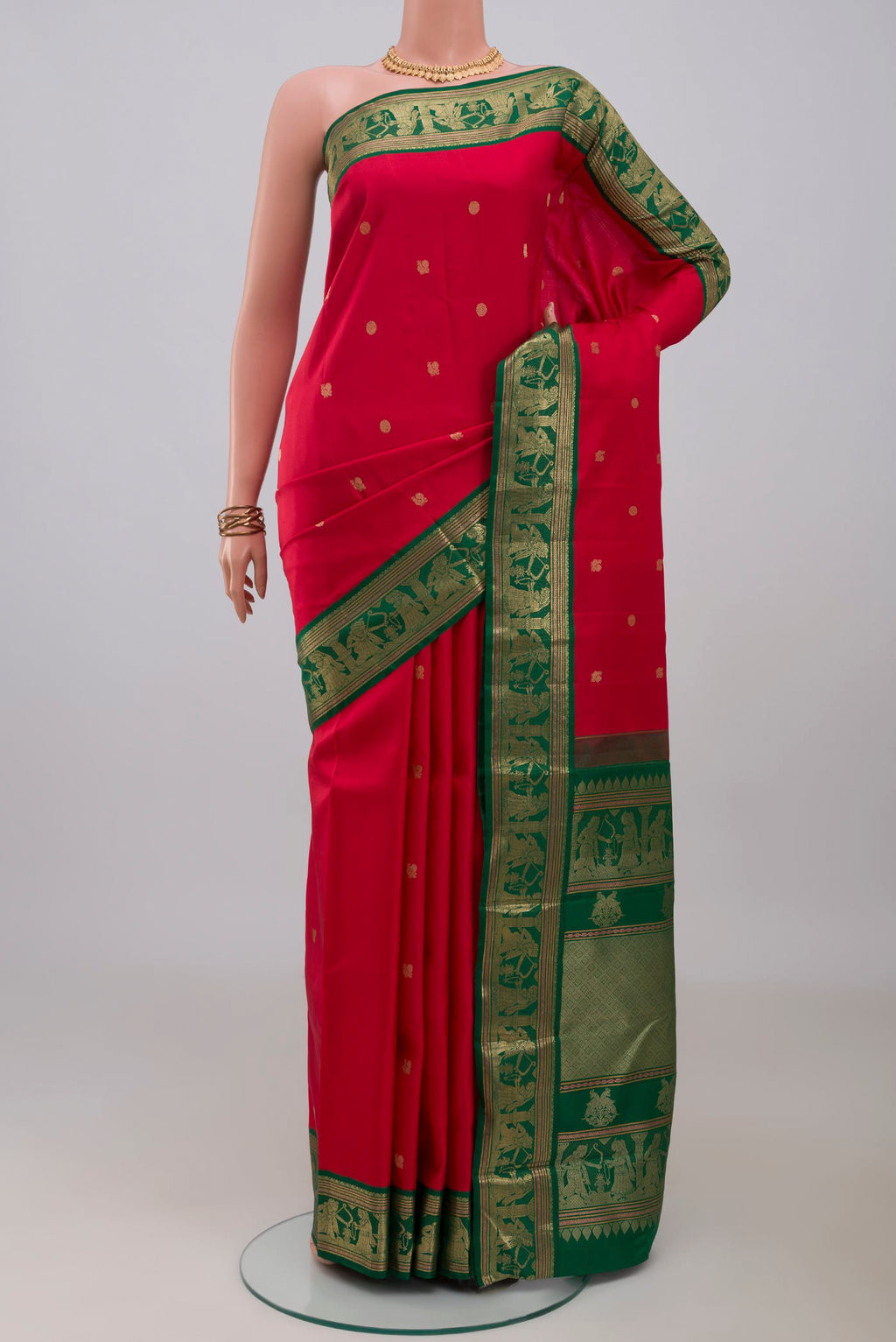 Red Kanjivaram Silk Saree with Zari Butta on the body and Zari Border.  displayed on a mannequin