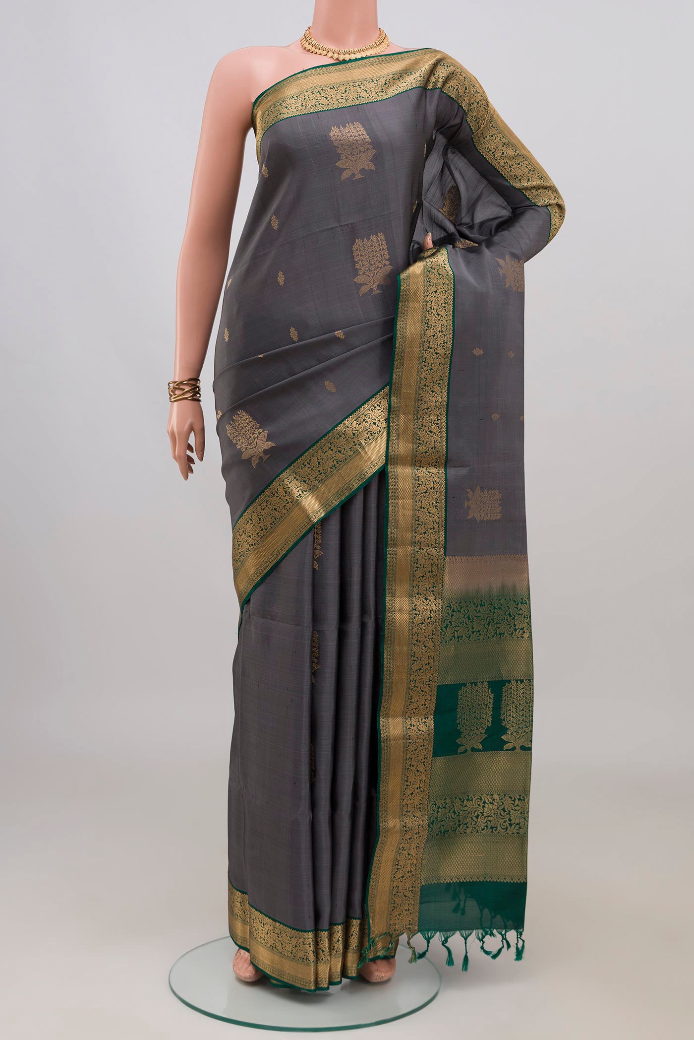 Pure Silk Grey Soft Saree with Zari Butta on the body and Zari Border.  displayed on a mannequin