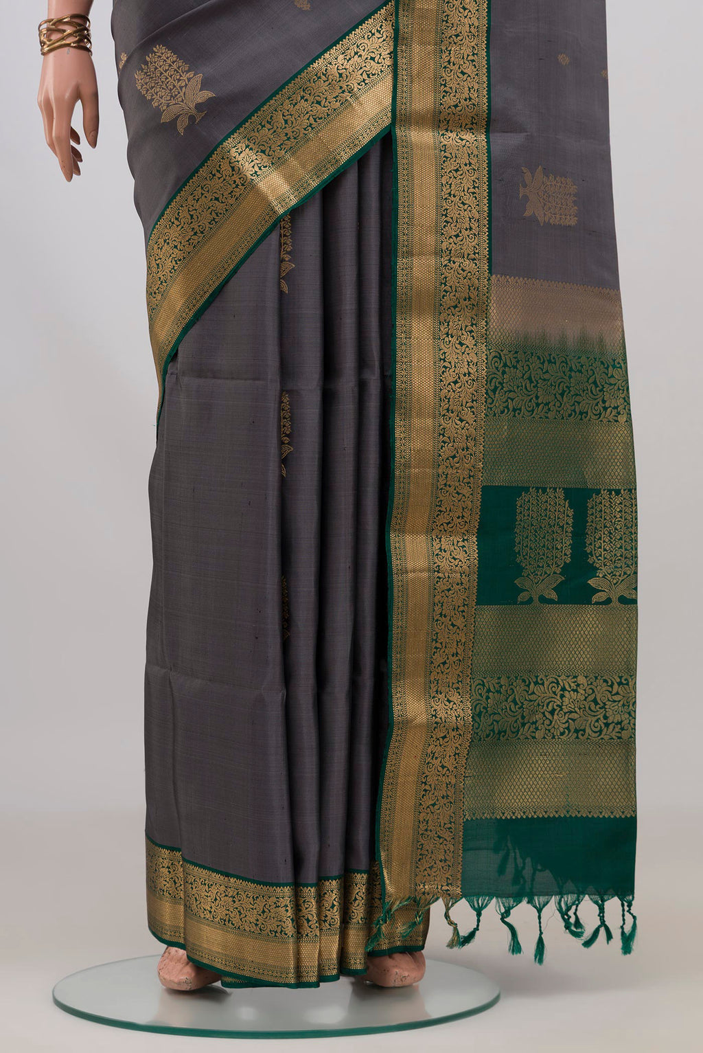 Pleats and pallu of Pure Silk Grey Soft Saree with Zari Butta on the body and Zari Border. 