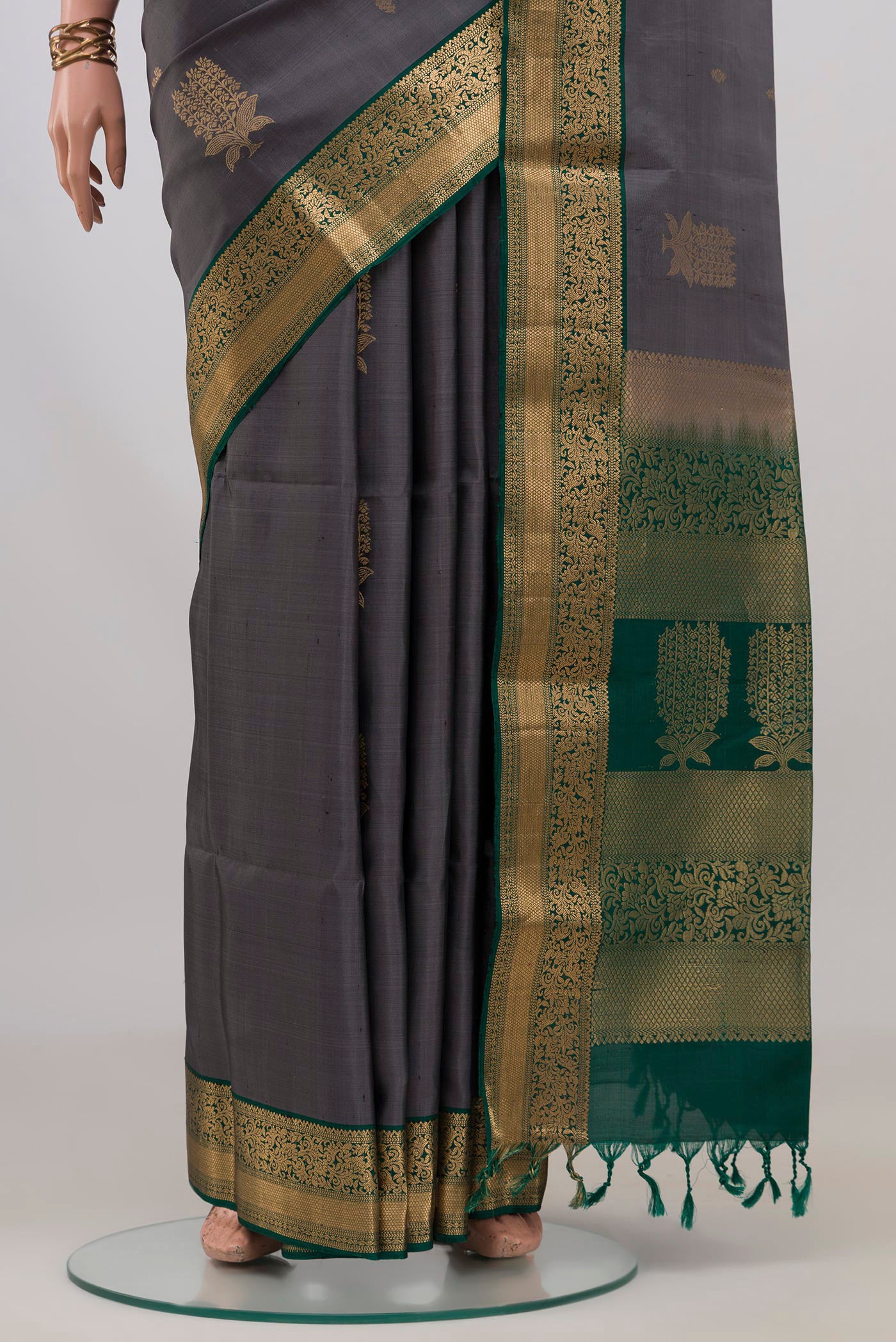 Pleats and pallu of Pure Silk Grey Soft Saree with Zari Butta on the body and Zari Border. 