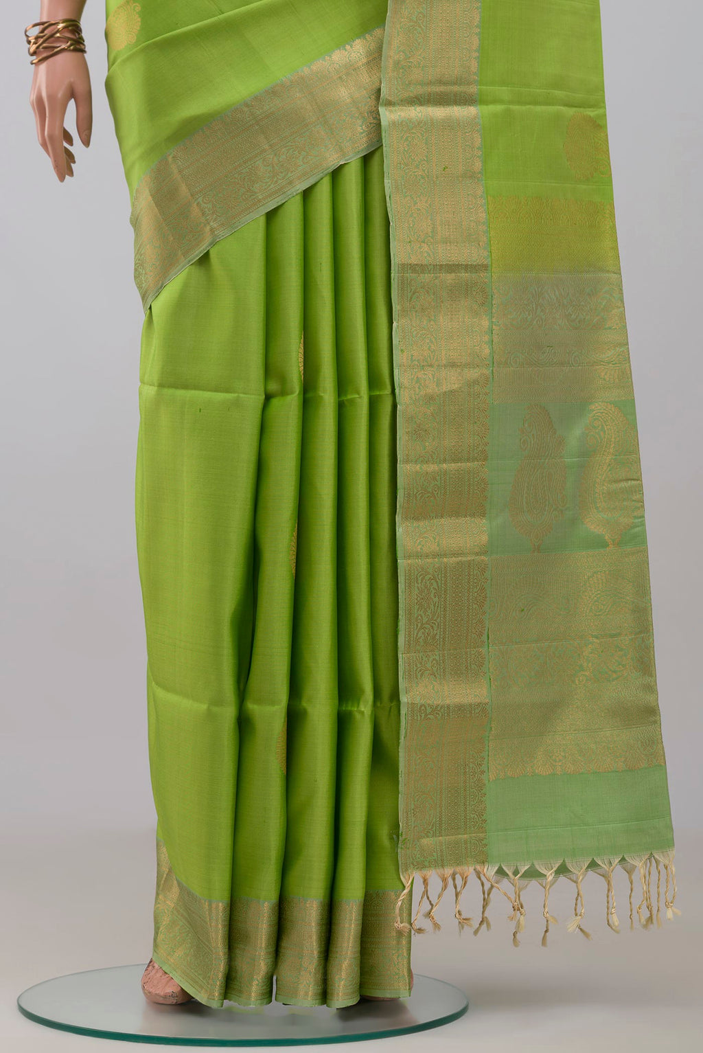 Pleats and pallu of Light Green Soft Silk Saree with Zari Butta on the body and Zari Border. 