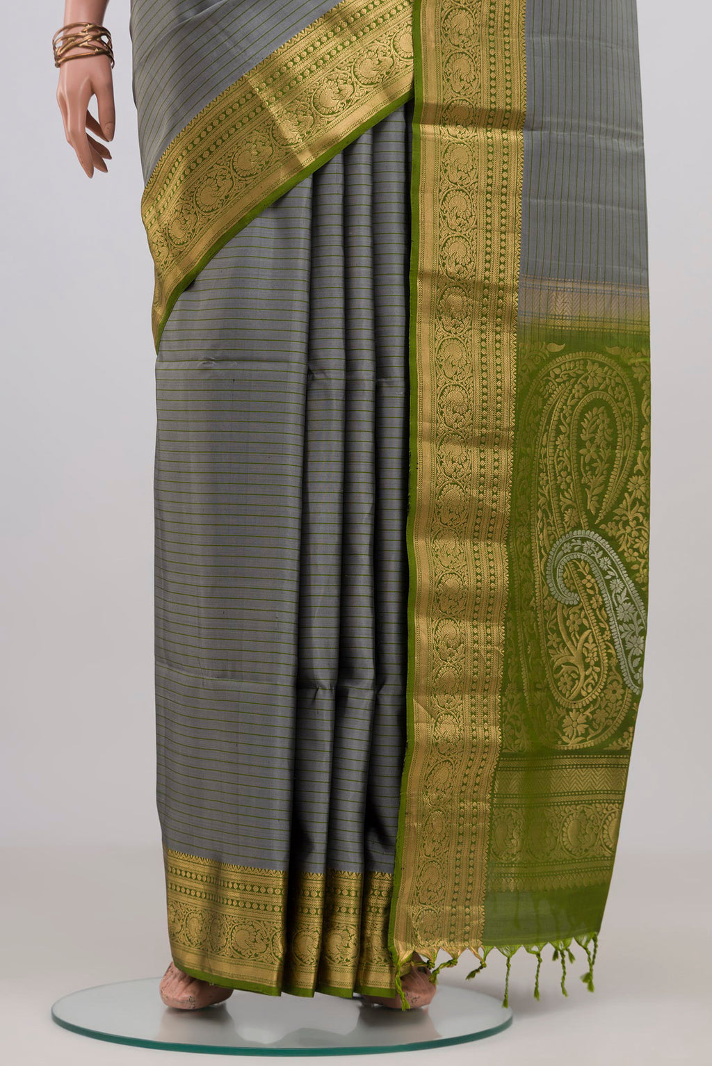 Pleats and pallu of Grey Soft Silk Saree with Stripes on the body and Zari Border. 