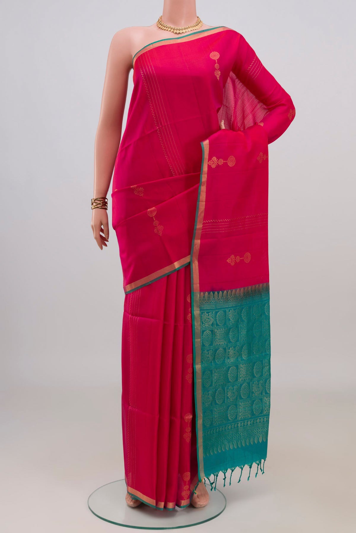Pure Silk Pink Soft Saree with Zari Butta on the body and Thin Zari Line.  displayed on a mannequin