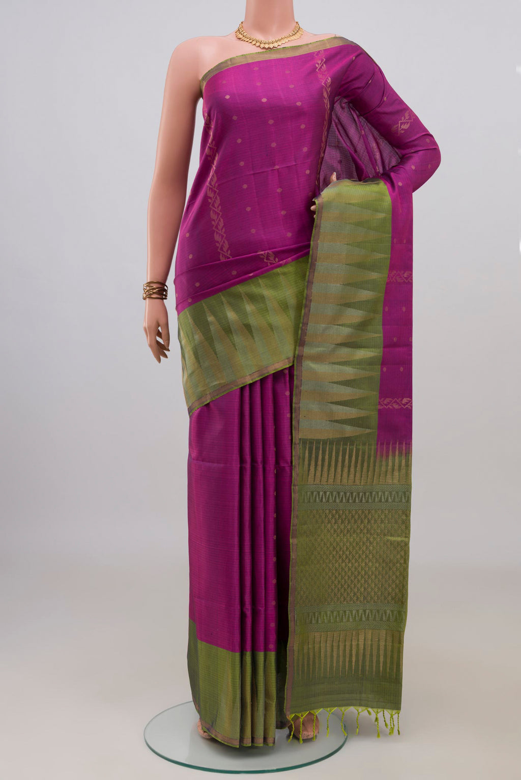 Pure Silk Magenta Soft Saree with Zari Butta on the body and Fancy Border.  displayed on a mannequin