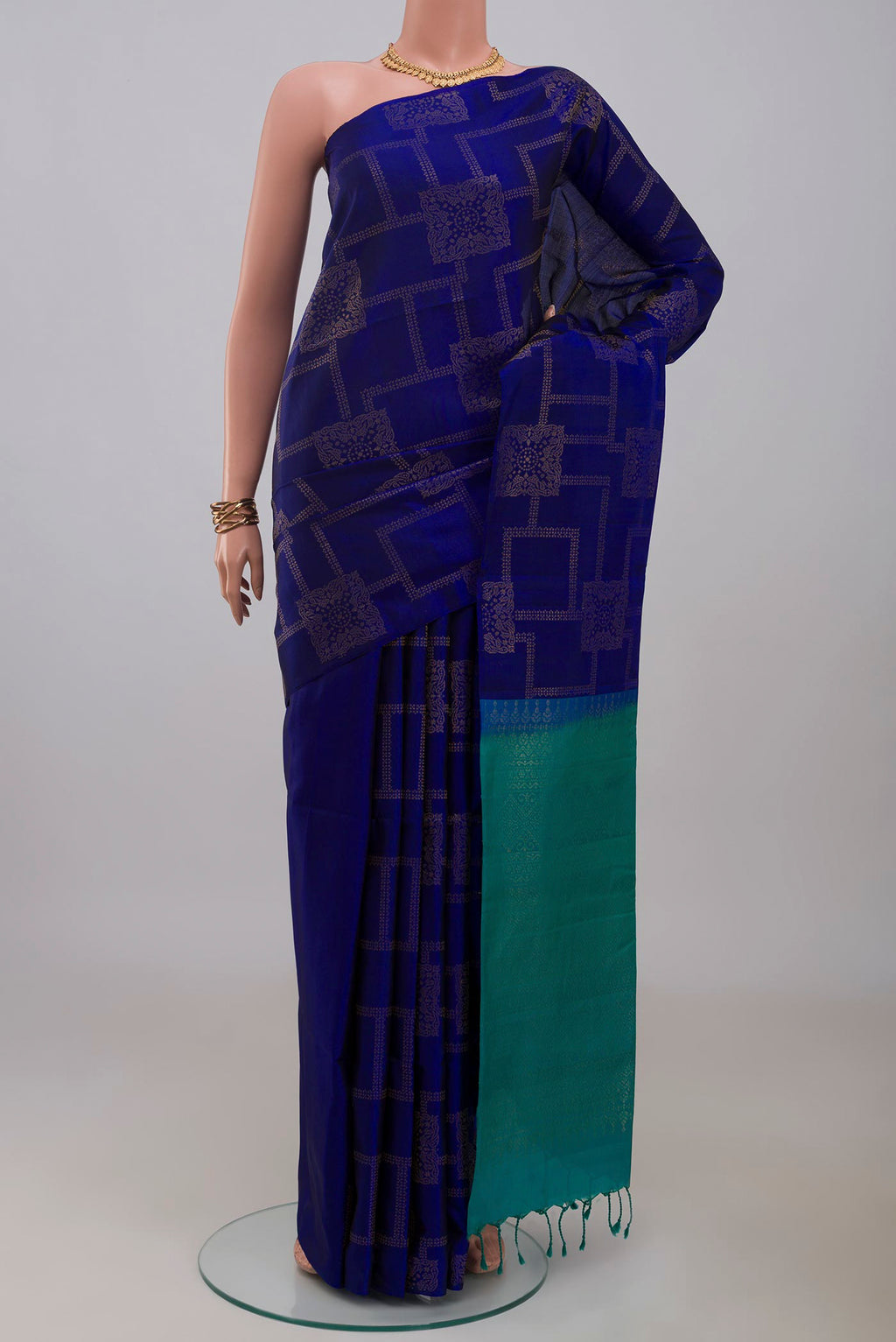 Blue Soft Silk Saree with Zari Butta on the body and Without Border.  displayed on a mannequin