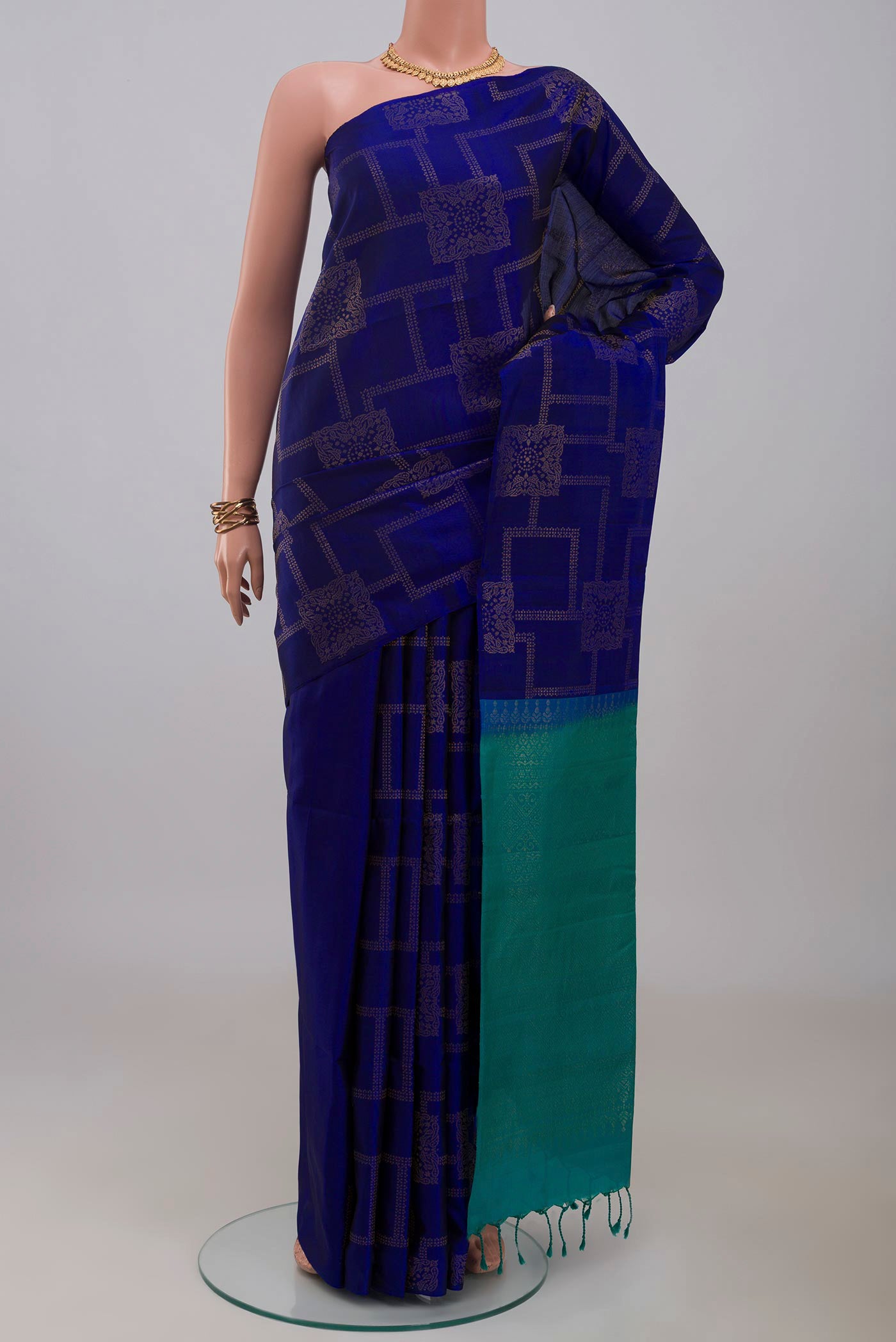 Blue Soft Silk Saree with Zari Butta on the body and Without Border.  displayed on a mannequin
