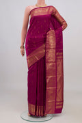 Magenta Kanchipuram Silk Saree with Zari Butta on the body and Zari Border.  displayed on a mannequin