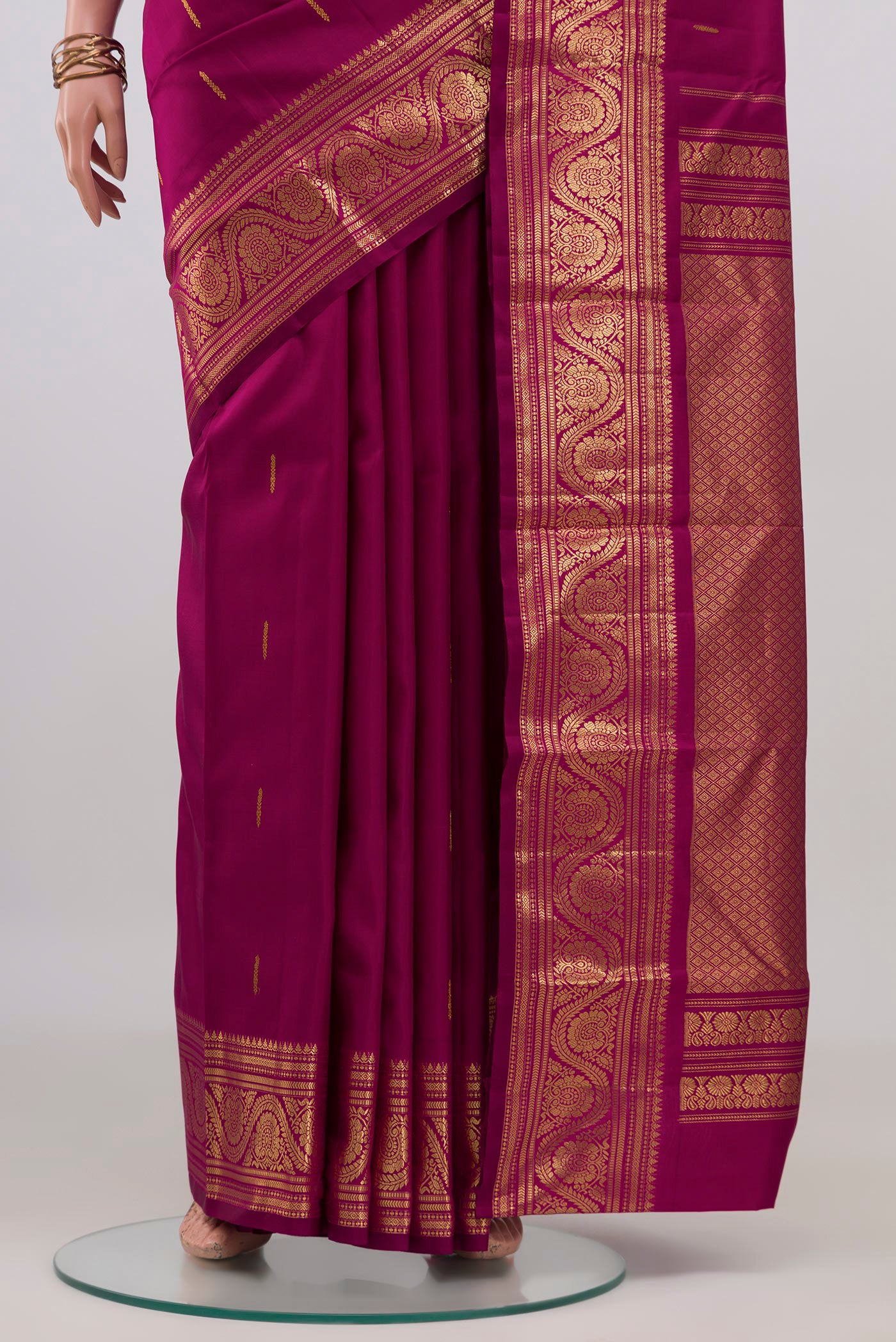 Pleats and pallu of Magenta Kanchipuram Silk Saree with Zari Butta on the body and Zari Border. 
