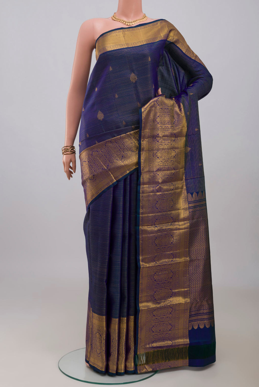 Blue Kanjivaram Silk Saree with Stripes on the body and Zari Border.  displayed on a mannequin