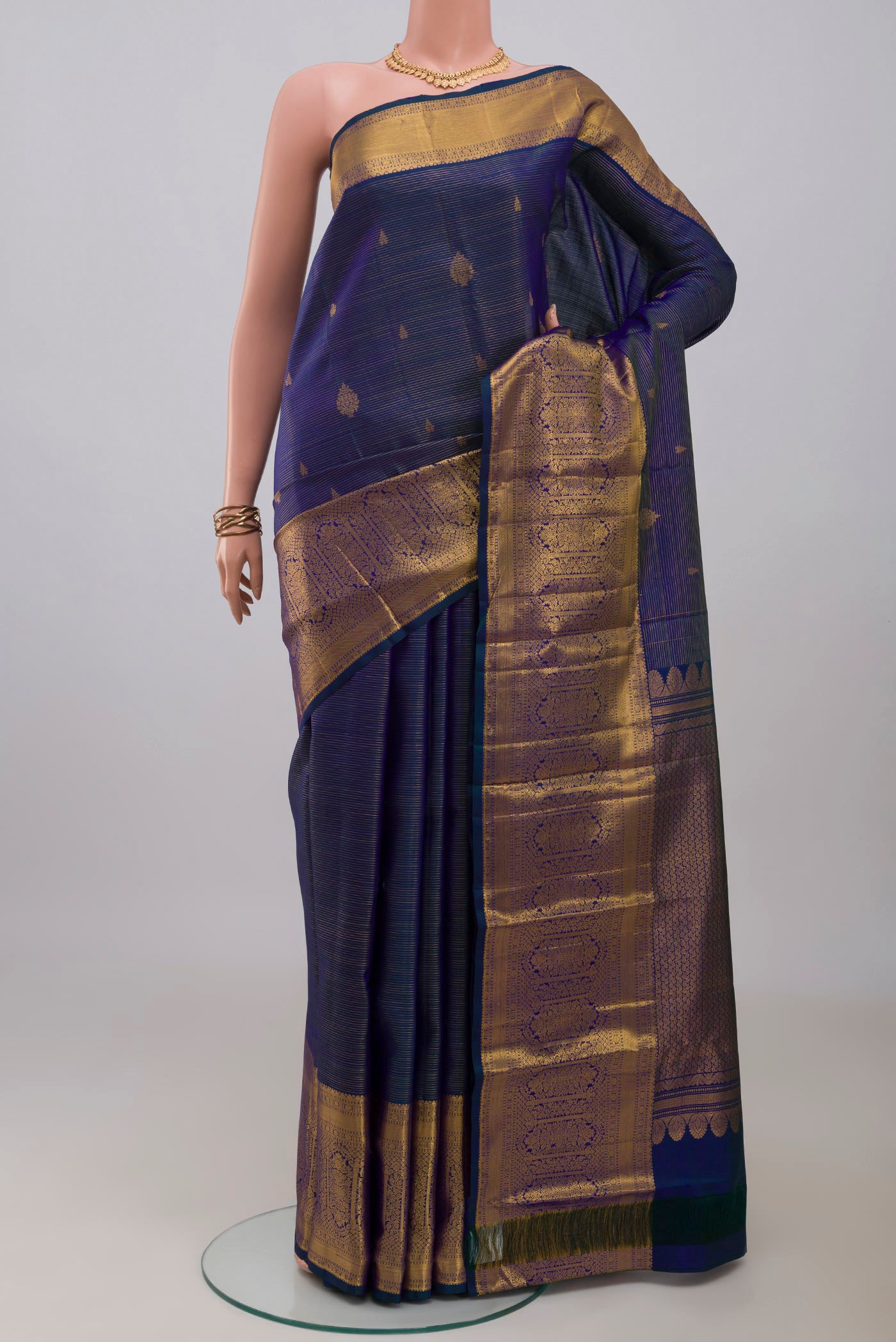 Blue Kanjivaram Silk Saree with Stripes on the body and Zari Border.  displayed on a mannequin