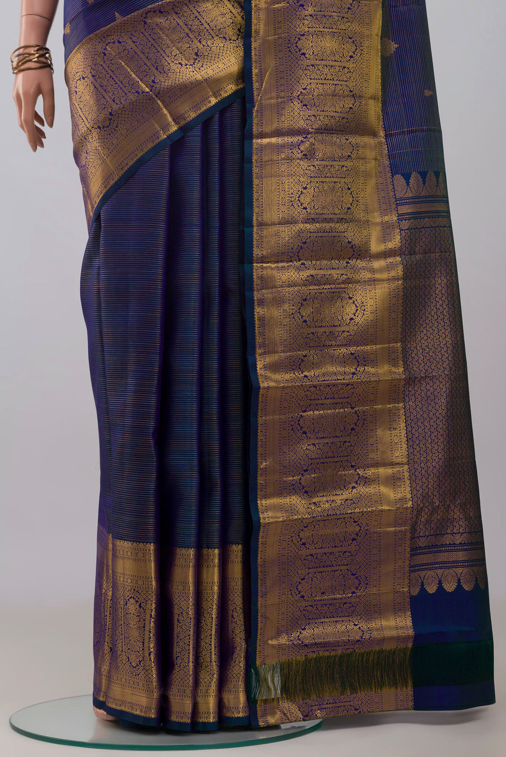 Pleats and pallu of Blue Kanjivaram Silk Saree with Stripes on the body and Zari Border. 