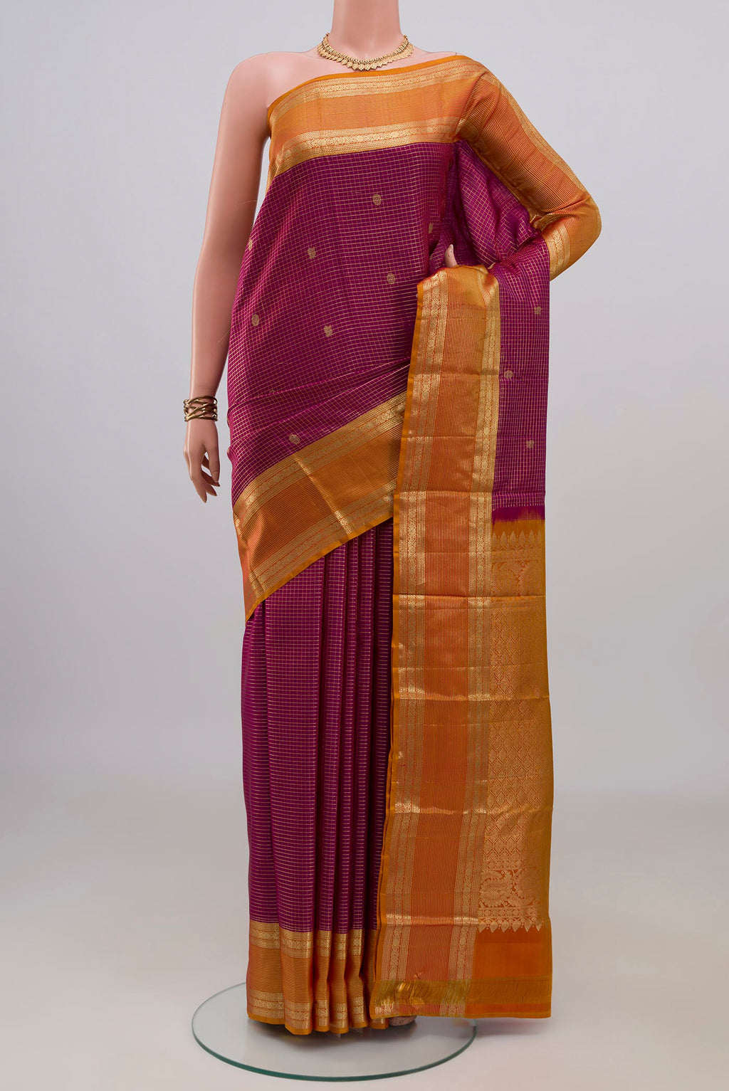Pure Silk Magenta Kanjivaram Saree with Checked design on the body and Zari Border.  displayed on a mannequin