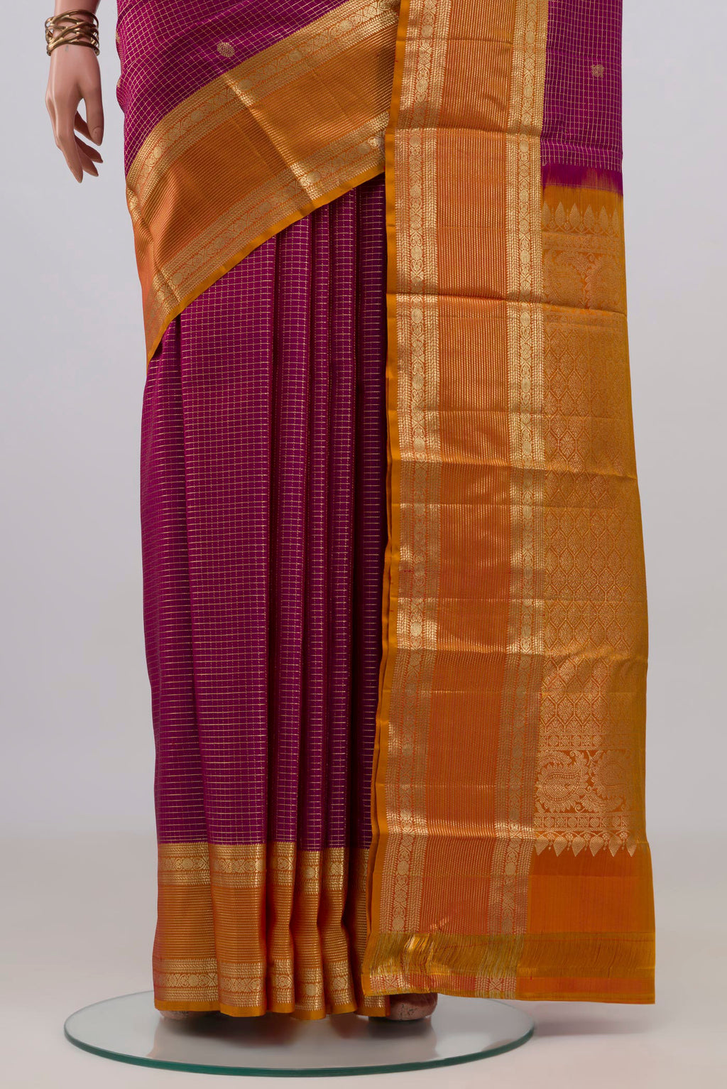 Pleats and pallu of Pure Silk Magenta Kanjivaram Saree with Checked design on the body and Zari Border. 