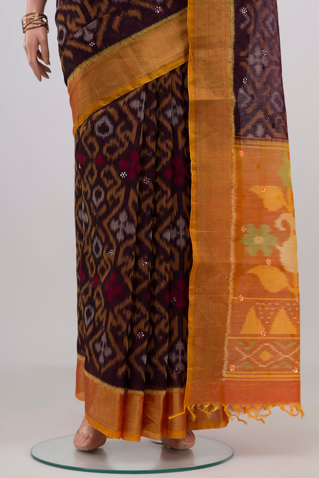 Pleats and pallu of Coffee Brown Silk Cotton Saree with Ikat design on the body and Zari Border. 