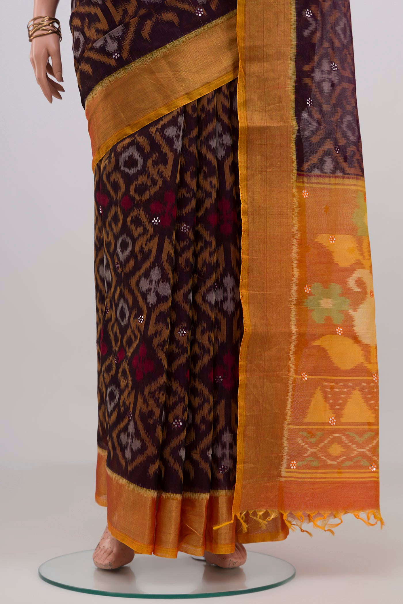 Pleats and pallu of Coffee Brown Silk Cotton Saree with Ikat design on the body and Zari Border. 