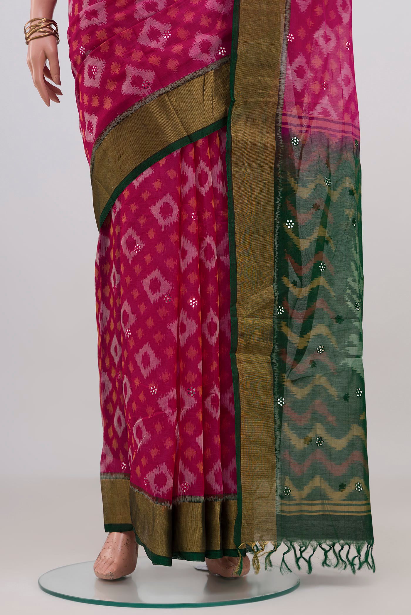 Pleats and pallu of Pink Silk Cotton Saree with Ikat design on the body and Zari Border. 