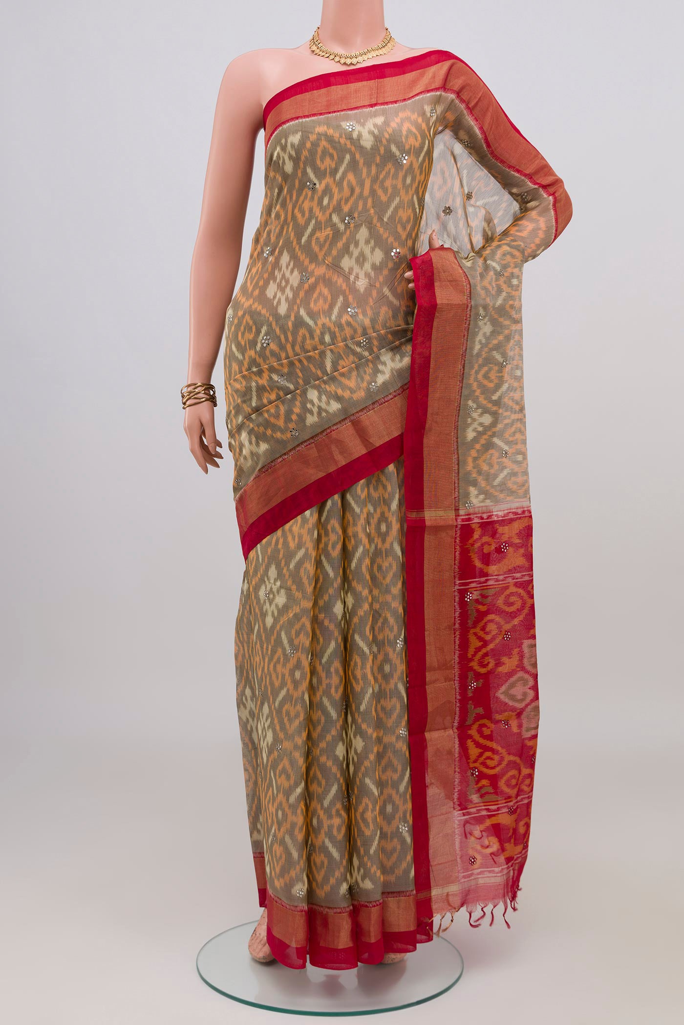 Grey Silk Cotton Saree with Ikat design on the body and Zari Border.  displayed on a mannequin