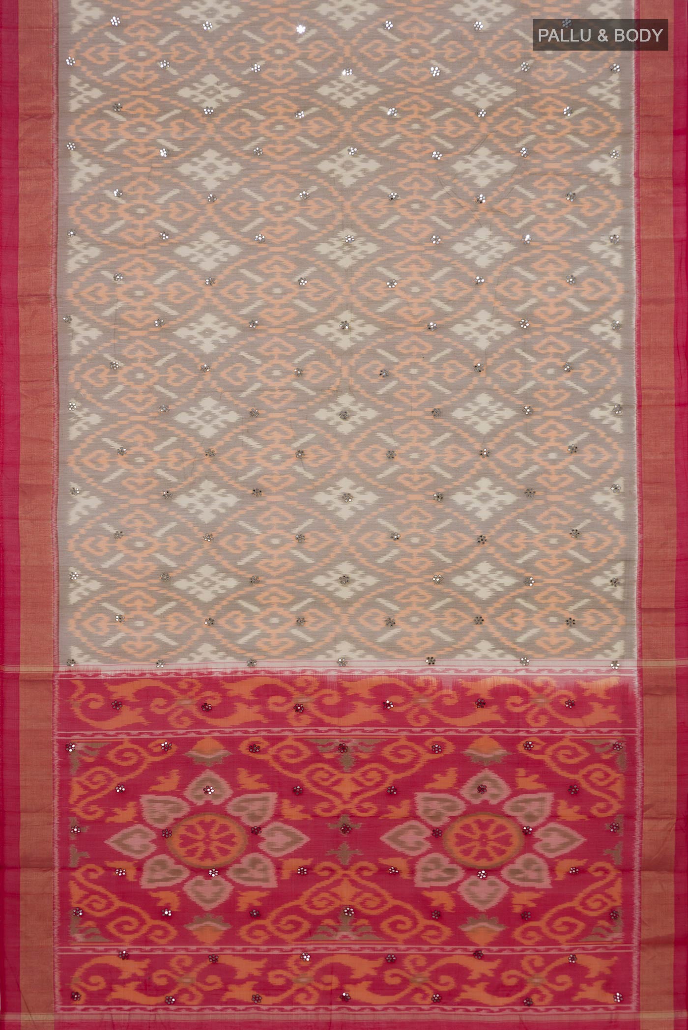 Flat view of Grey Silk Cotton Saree with Ikat design on the body and Zari Border. 