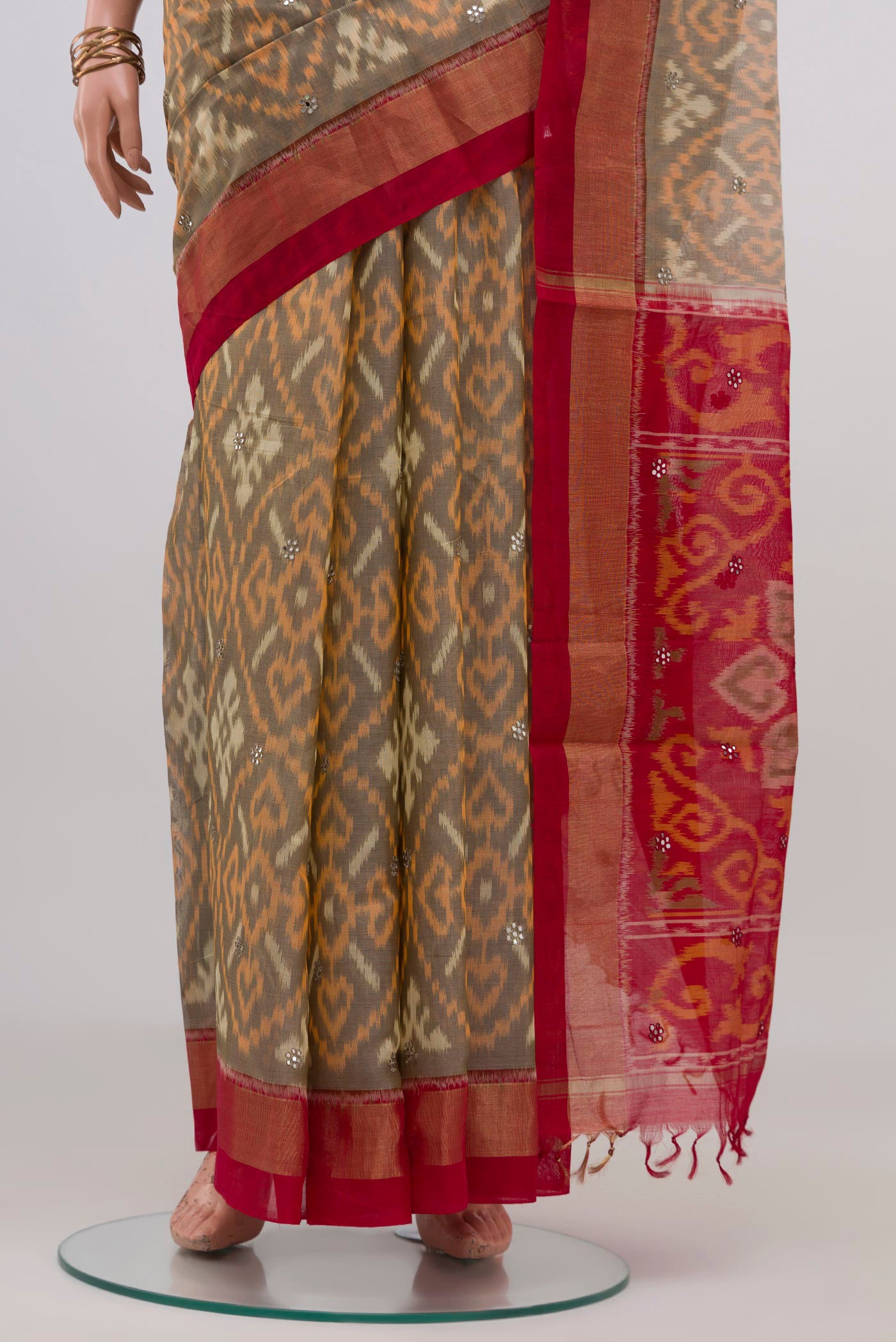 Pleats and pallu of Grey Silk Cotton Saree with Ikat design on the body and Zari Border. 