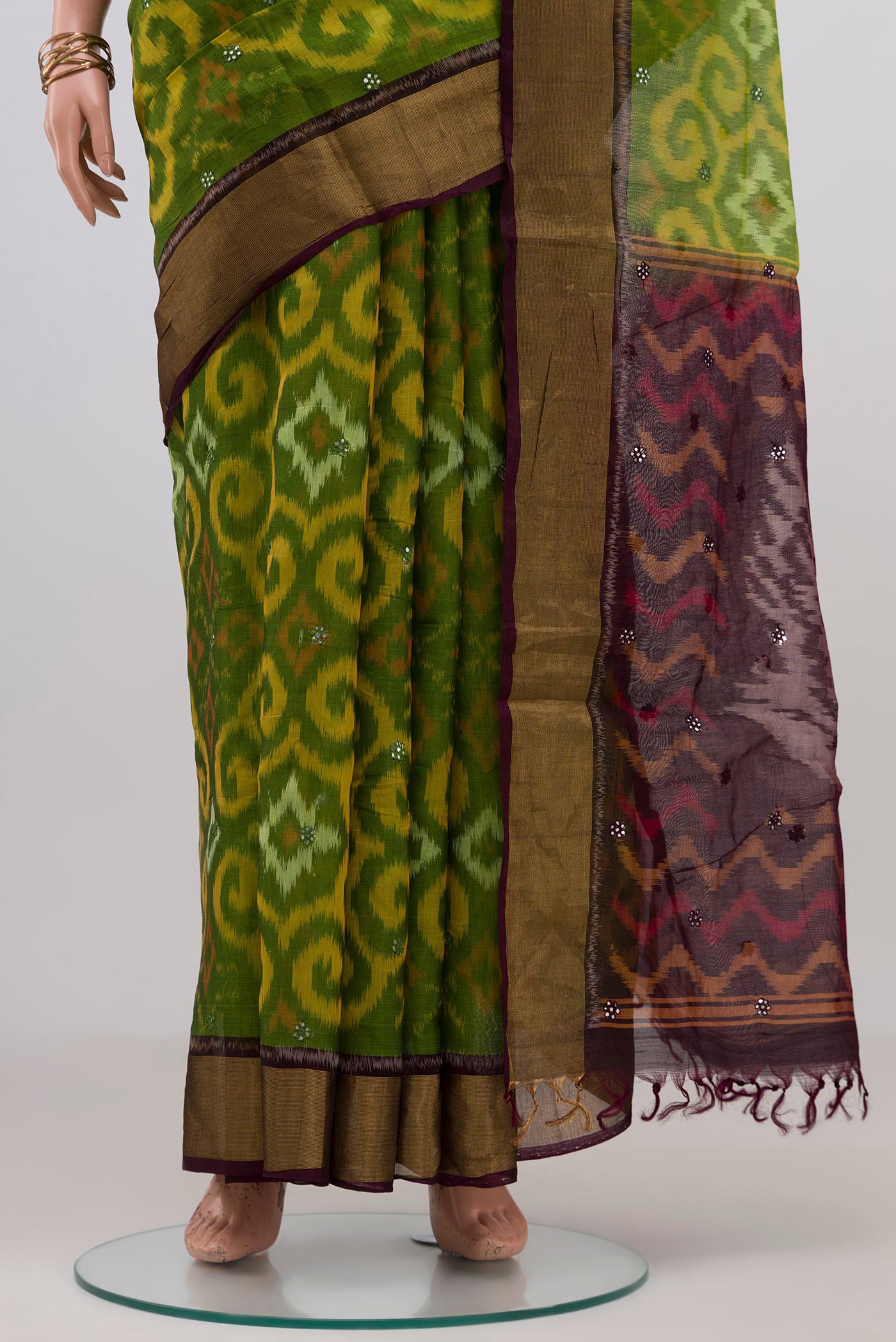 Pleats and pallu of Green Silk Cotton Saree with Ikat Print on the body and Zari Border. 