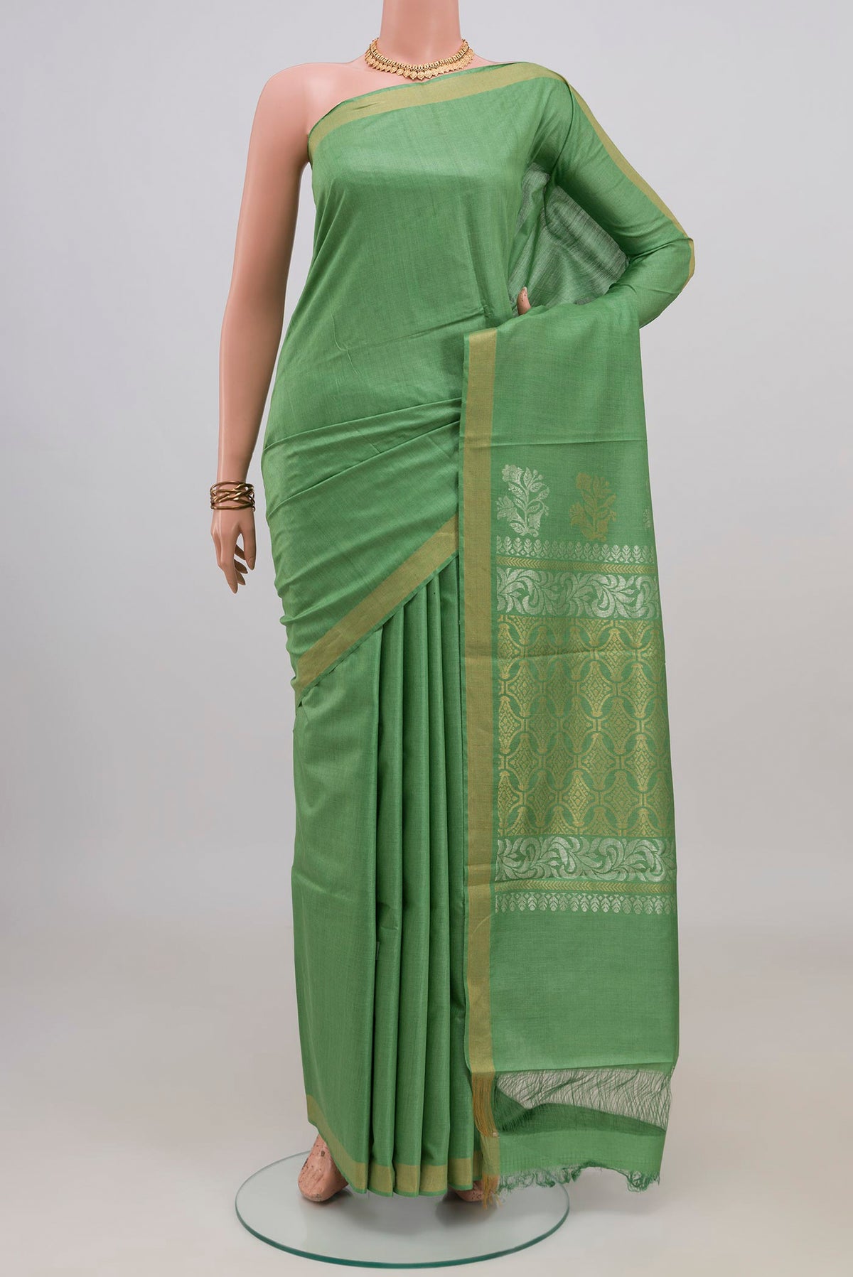Pista Green Tussar Silk Saree with Plain Body and Zari Border.  displayed on a mannequin