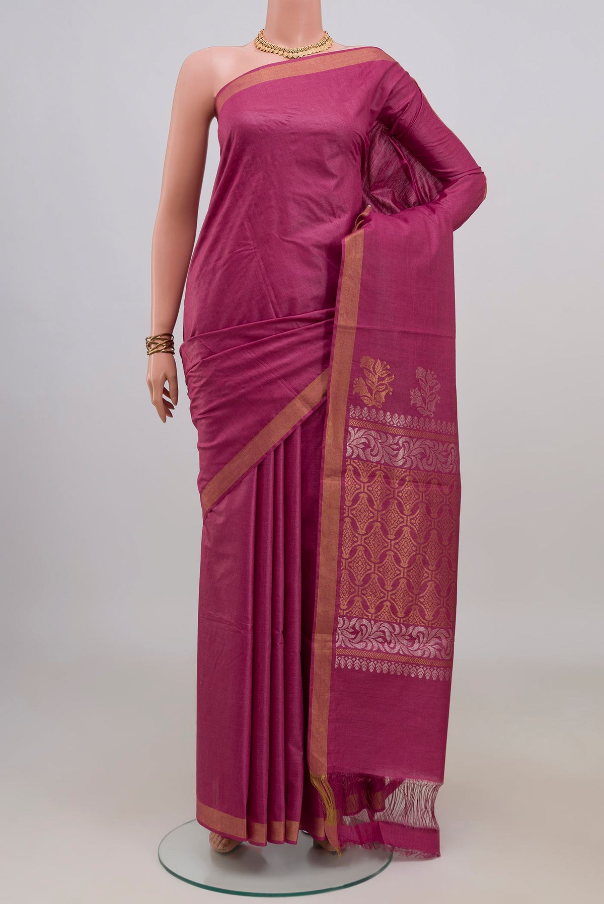 Pink Tussar Saree with Plain Body and Zari Border.  displayed on a mannequin