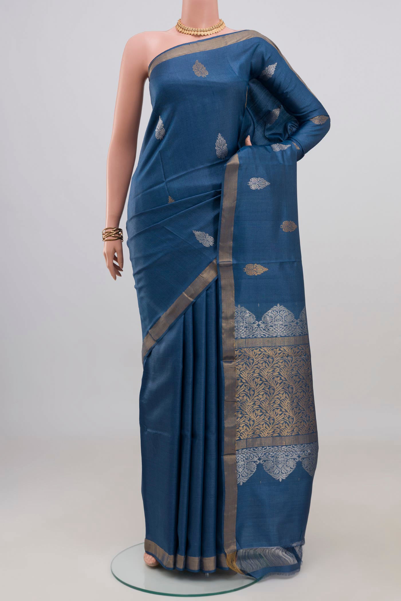 Blue Tussar Silk Saree with Zari Butta on the body and Zari Border.  displayed on a mannequin