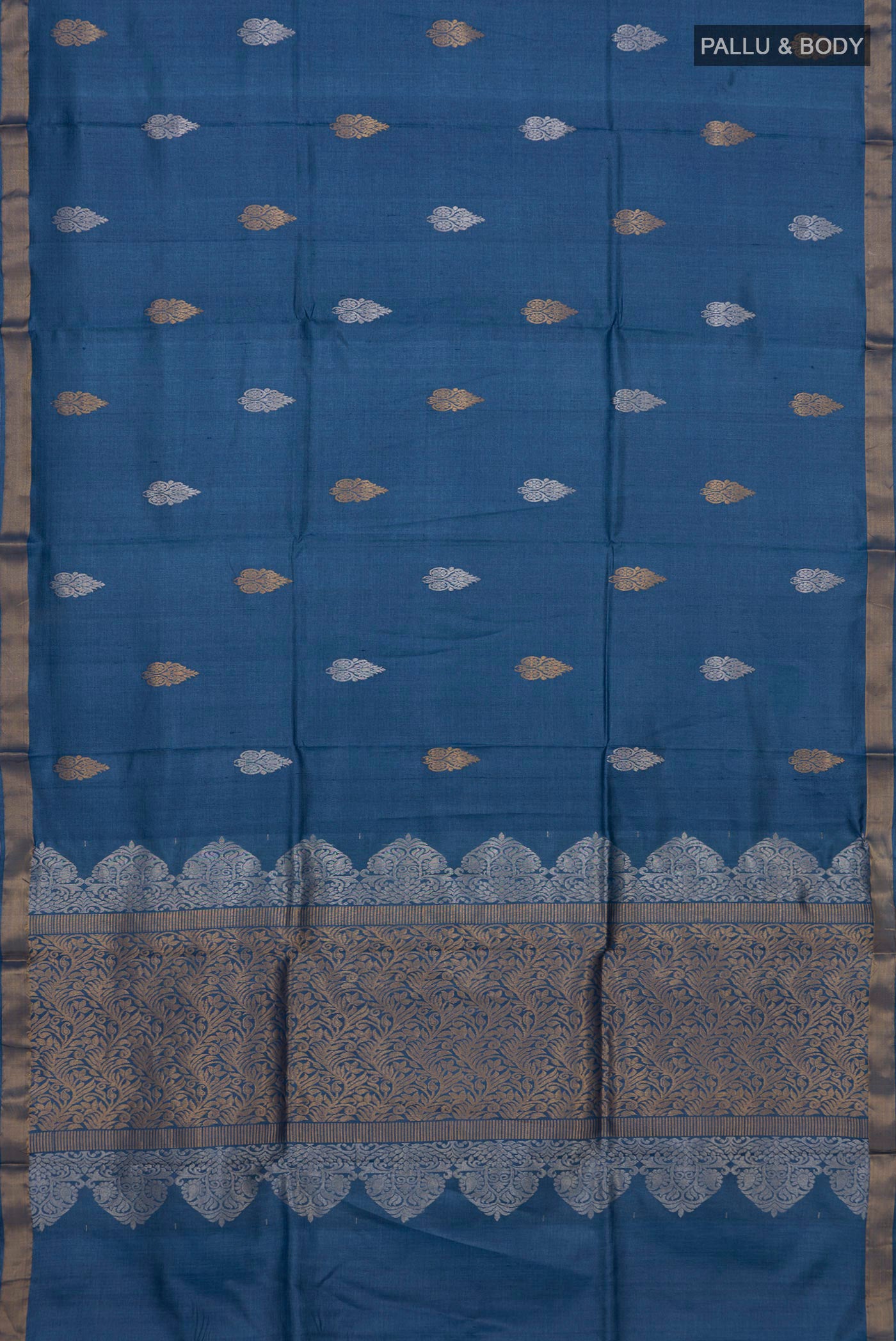 Flat view of Blue Tussar Silk Saree with Zari Butta on the body and Zari Border. 