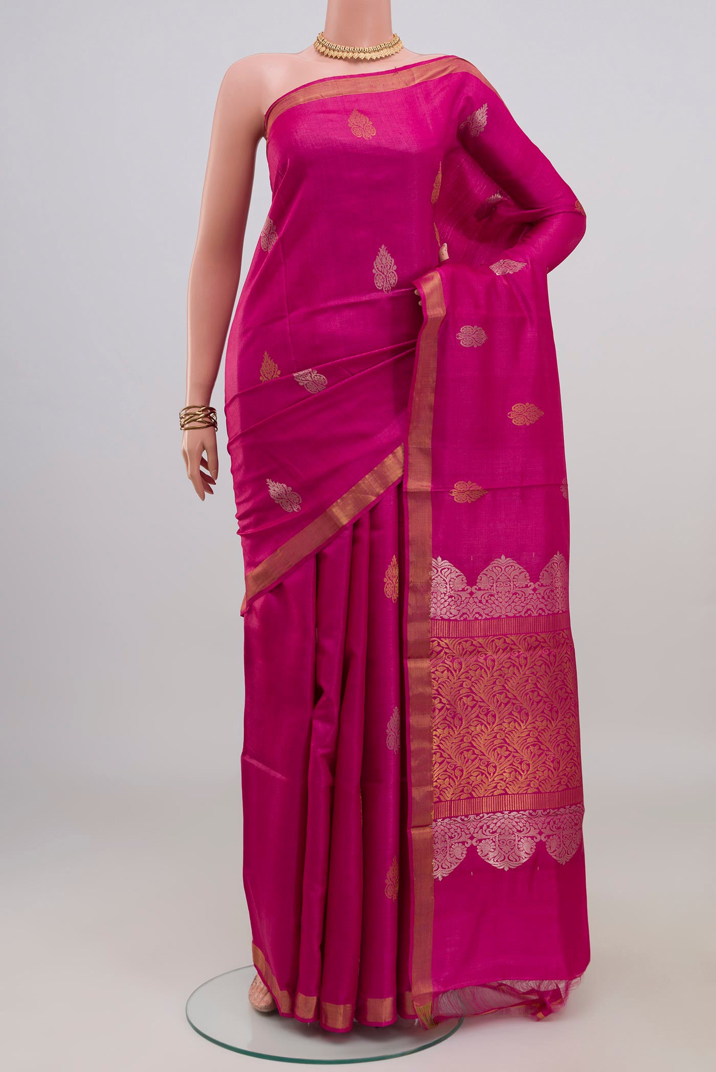 Rani Pink Tussar Silk Saree with Zari Butta on the body and Zari Border.  displayed on a mannequin