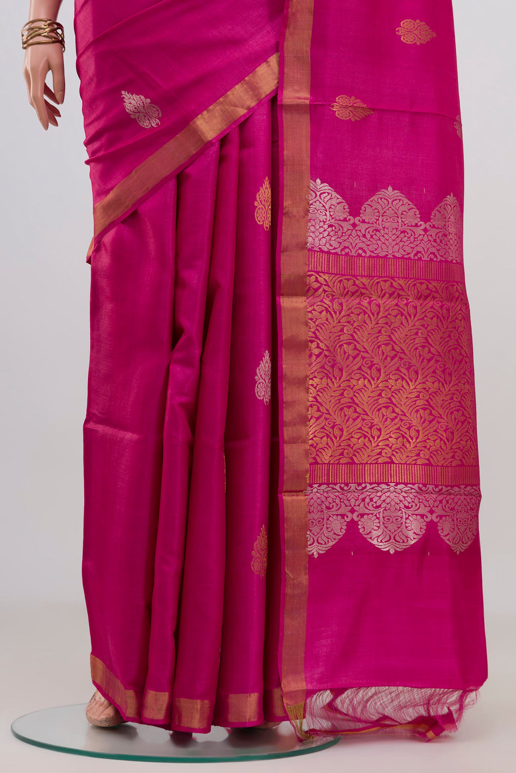 Pleats and pallu of Rani Pink Tussar Silk Saree with Zari Butta on the body and Zari Border. 