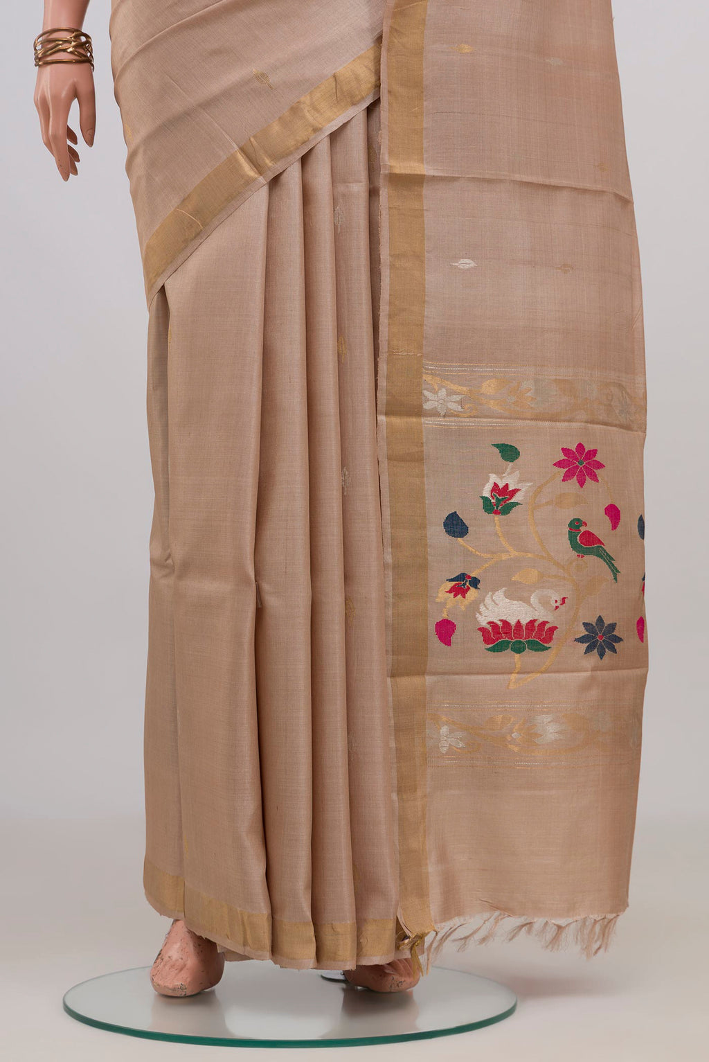 Pleats and pallu of Beige Tussar Silk Saree with Zari Butta on the body and Zari Border. 