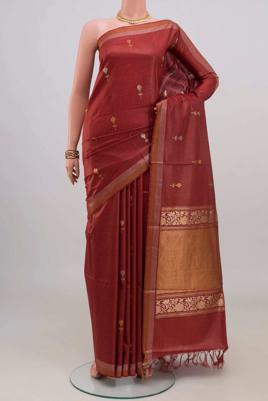 Brown Tussar Silk Saree with Zari Butta on the body and Zari Border.  displayed on a mannequin