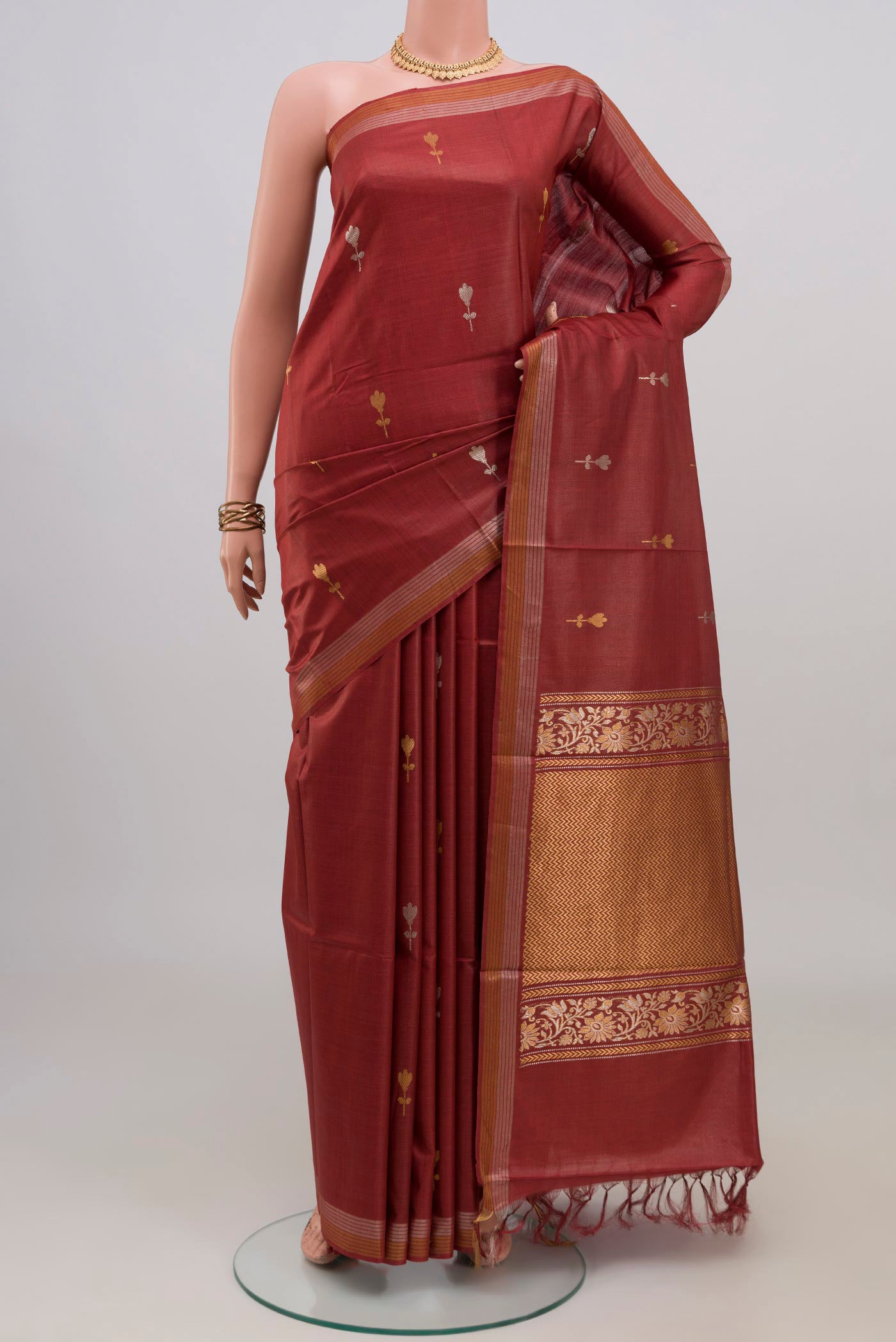 Brown Tussar Silk Saree with Zari Butta on the body and Zari Border.  displayed on a mannequin