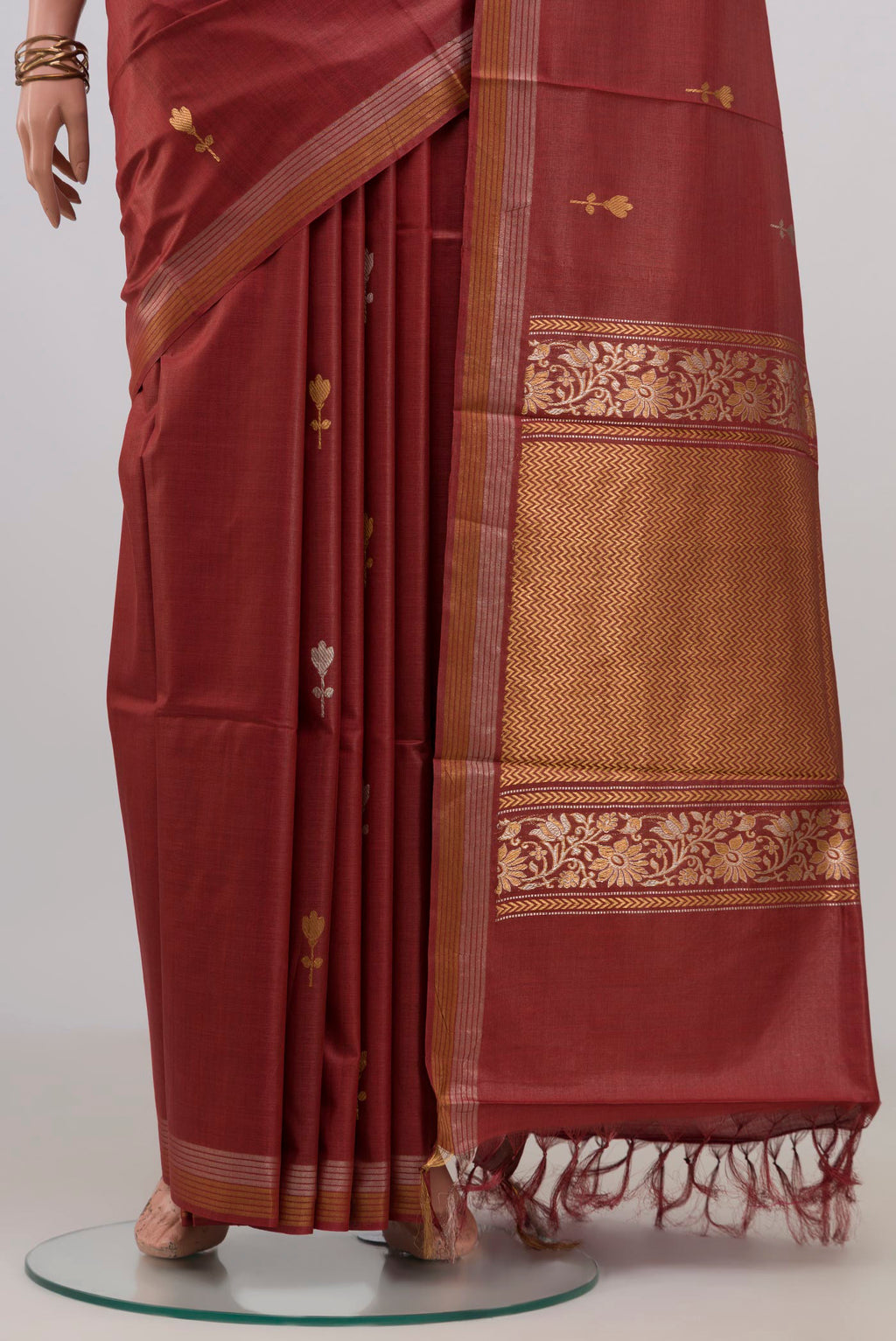 Pleats and pallu of Brown Tussar Silk Saree with Zari Butta on the body and Zari Border. 