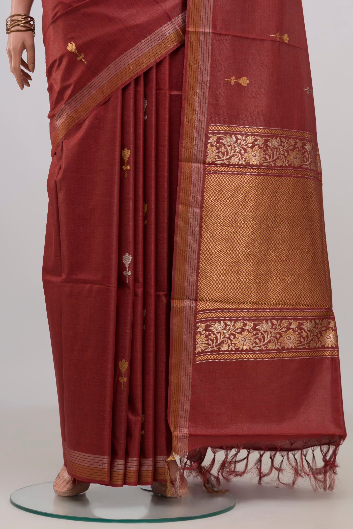 Pleats and pallu of Brown Tussar Silk Saree with Zari Butta on the body and Zari Border. 