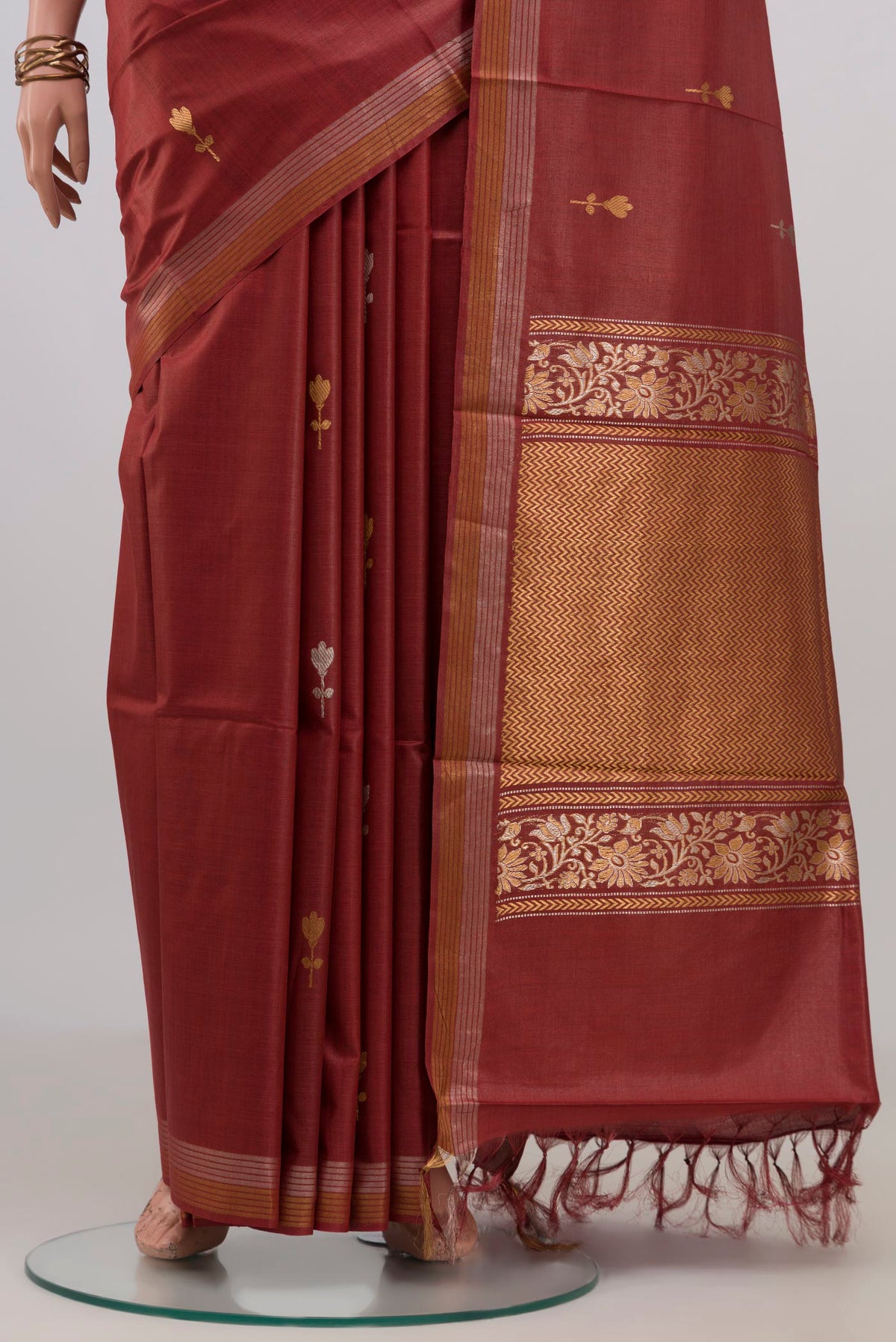 Pleats and pallu of Brown Tussar Silk Saree with Zari Butta on the body and Zari Border. 