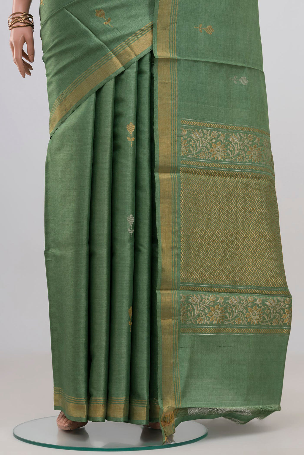 Pleats and pallu of Sage Green Tussar Silk Saree with Zari Butta on the body and Zari Border. 