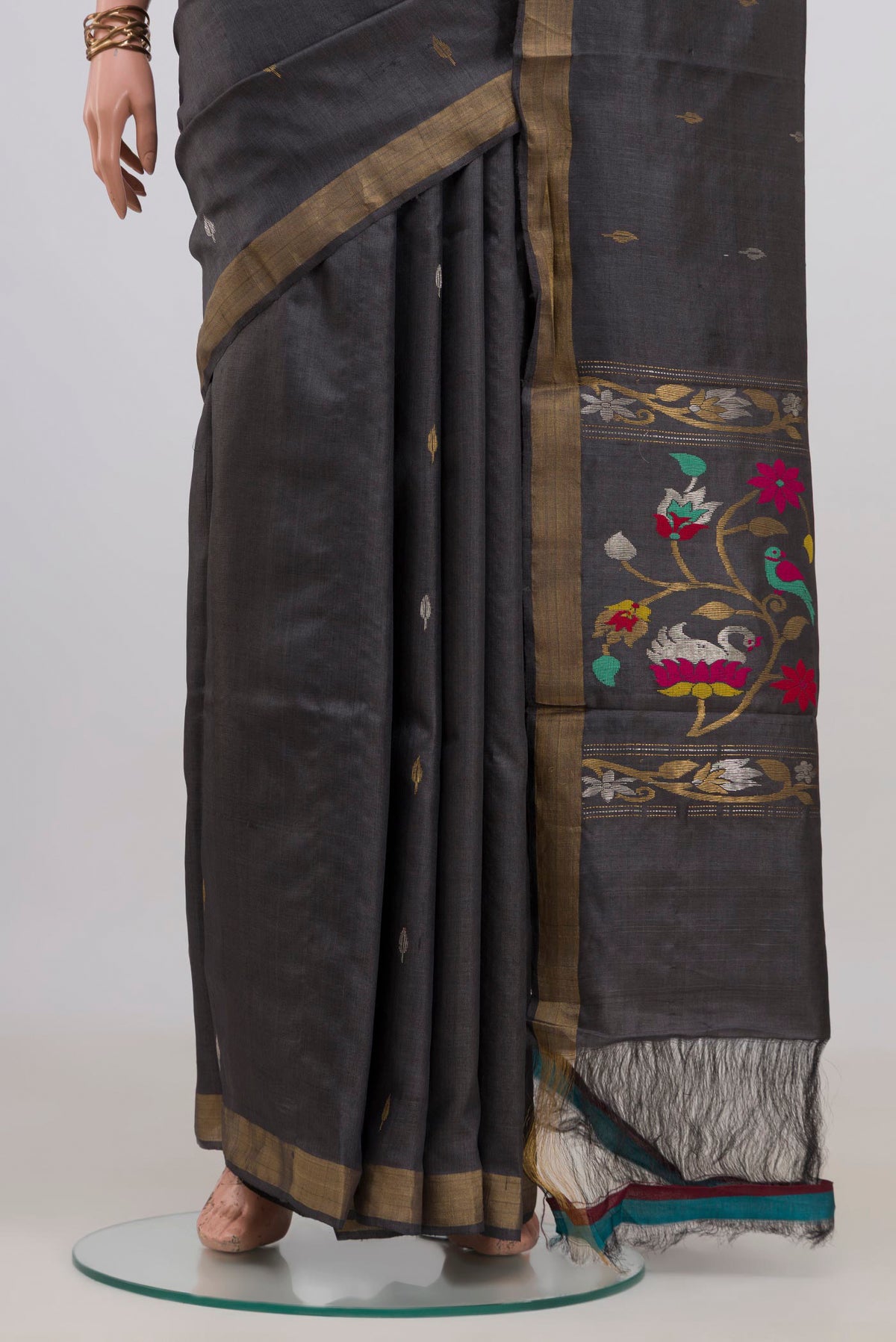 Pleats and pallu of Grey Tussar Saree with Zari Butta on the body and Zari Border. 