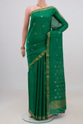 Green Tussar Silk Saree with Zari Butta on the body and Zari Border.  displayed on a mannequin