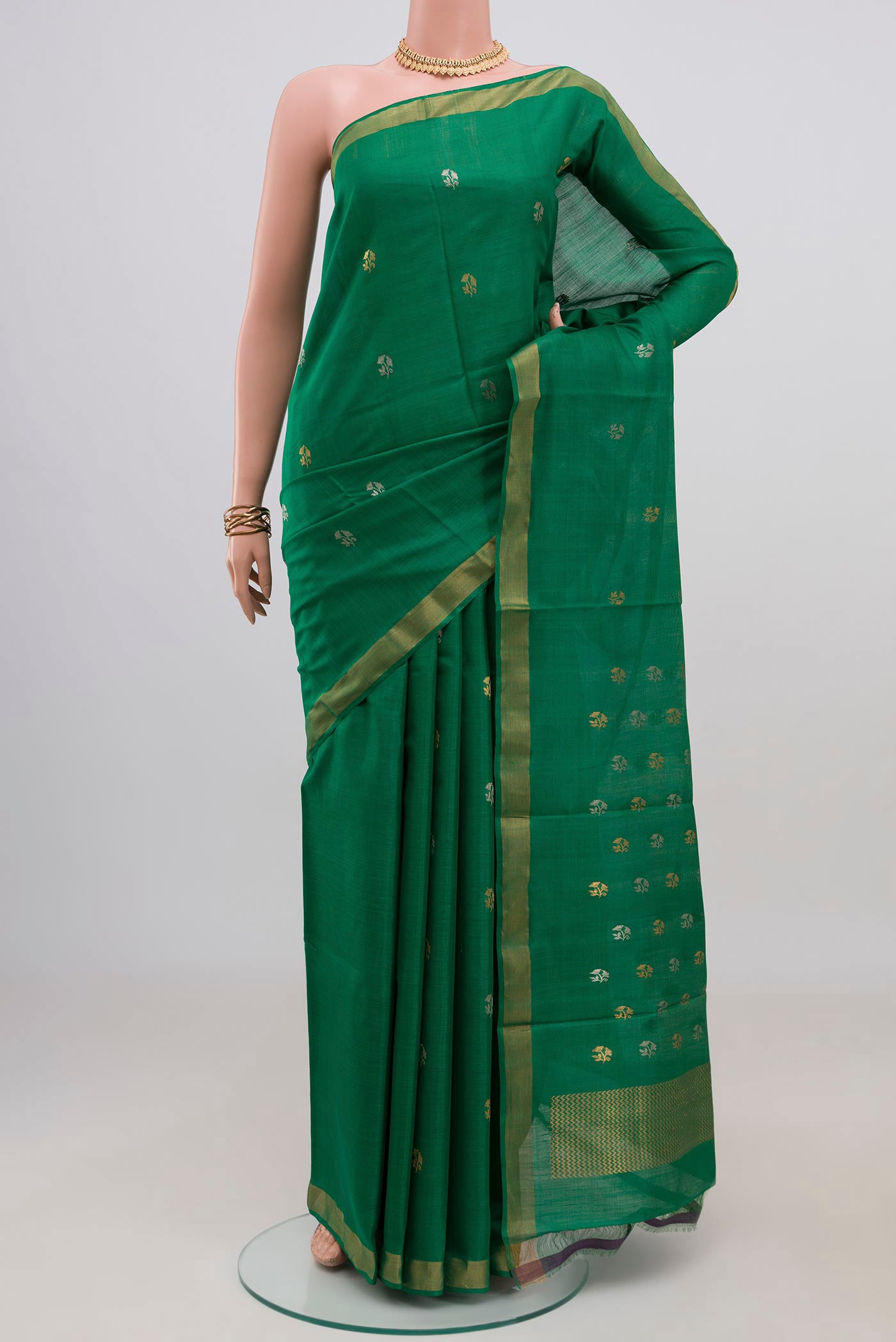 Green Tussar Silk Saree with Zari Butta on the body and Zari Border.  displayed on a mannequin