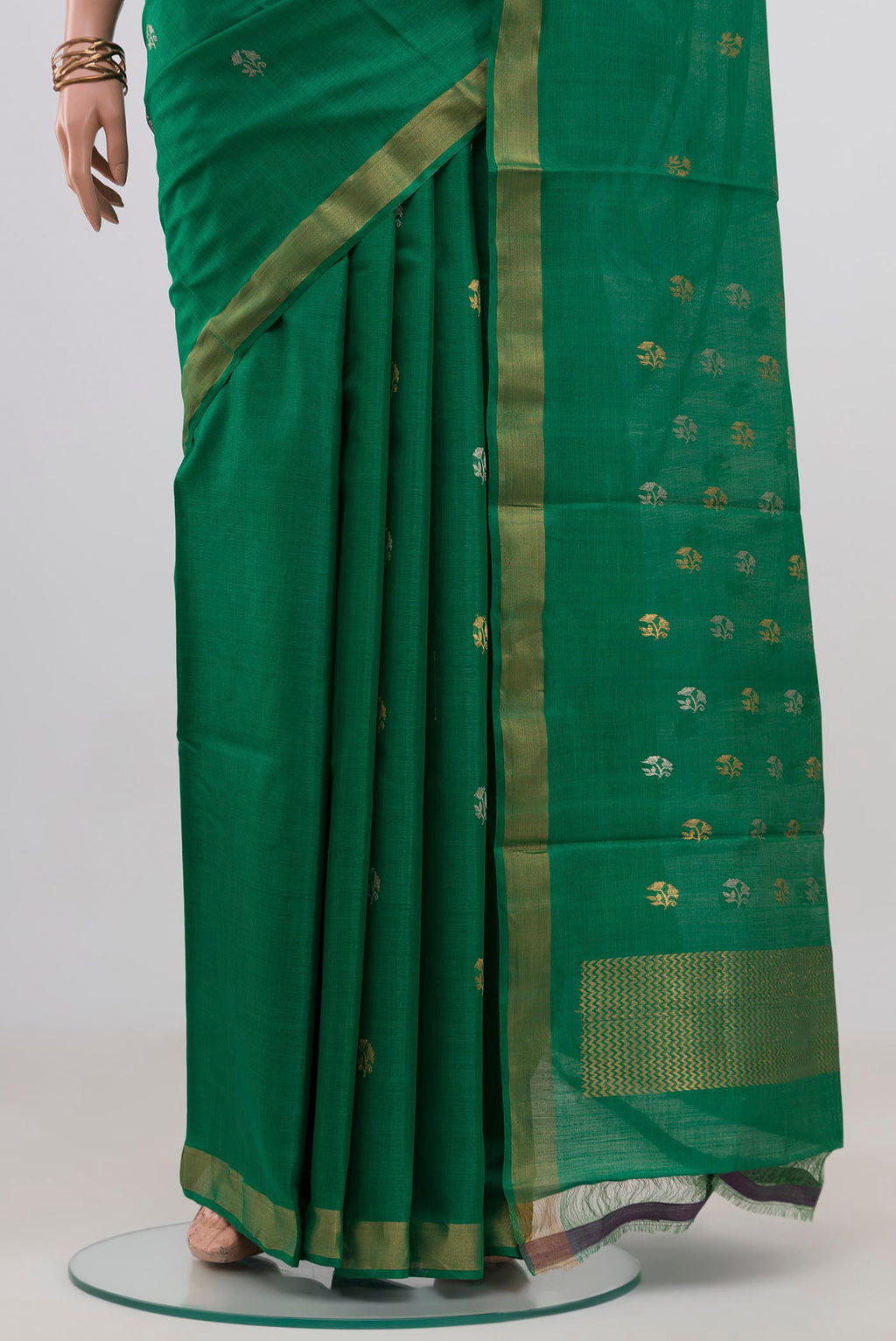 Pleats and pallu of Green Tussar Silk Saree with Zari Butta on the body and Zari Border. 