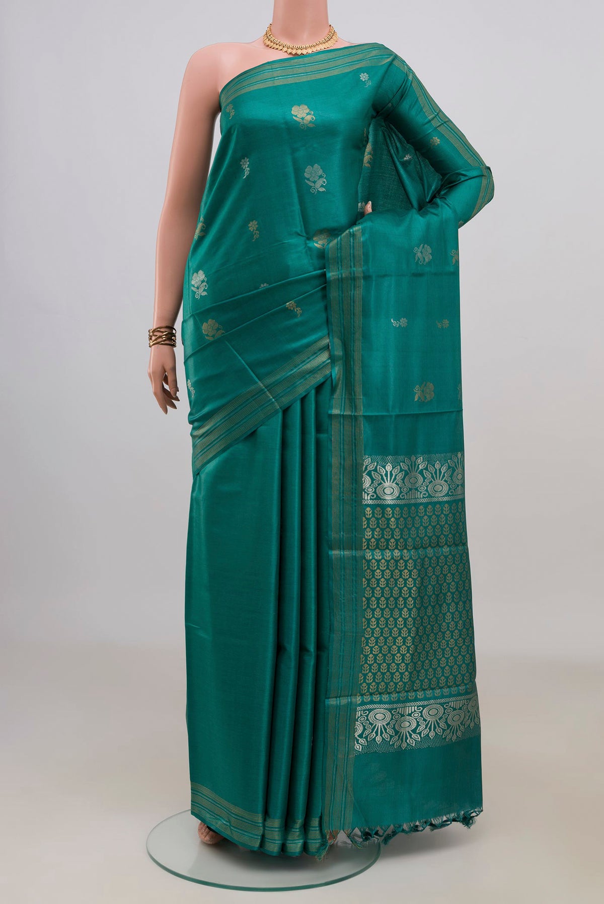 Pure Silk Green Tussar Saree with Zari Butta on the body and Zari Border.  displayed on a mannequin