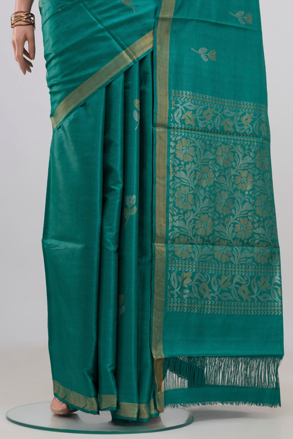 Pleats and pallu of Teal Tussar Silk Saree with Zari Butta on the body and Zari Border. 