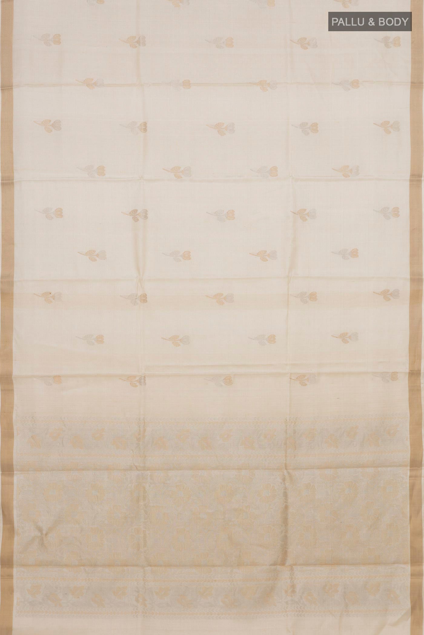 Flat view of Cream Tussar Silk Saree with Zari Butta on the body and Zari Border. 